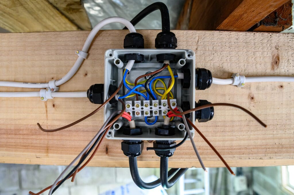 Exposed Wiring junction box half complete ready for operation in home garage. home diy